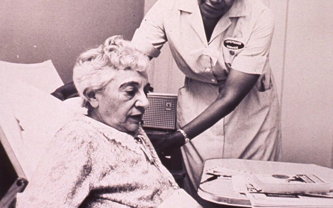 Caregiver and nurse providing home care assistance to a bedridden senior patient in Singapore